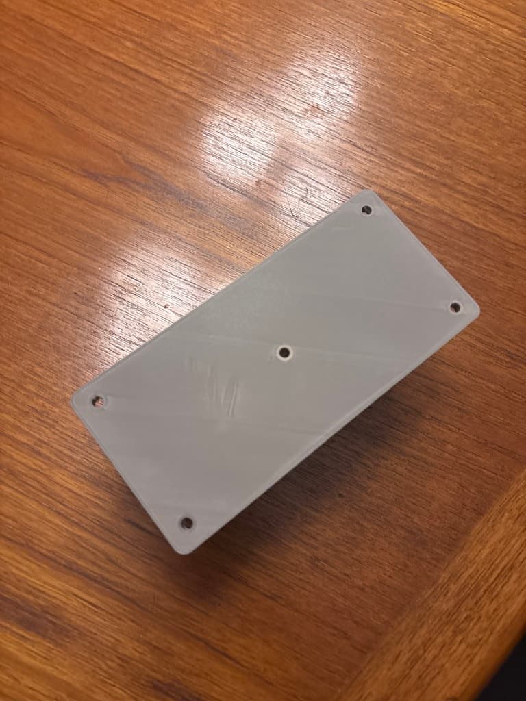 Top of the printed rectangular platform, showing four corner holes and one center hole.