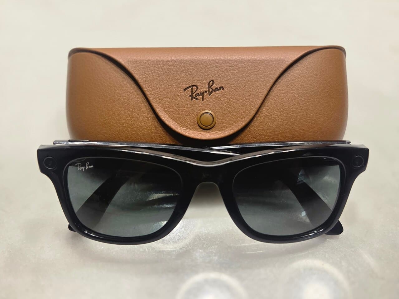 Ray-Ban Meta smart glasses resting on their charging case